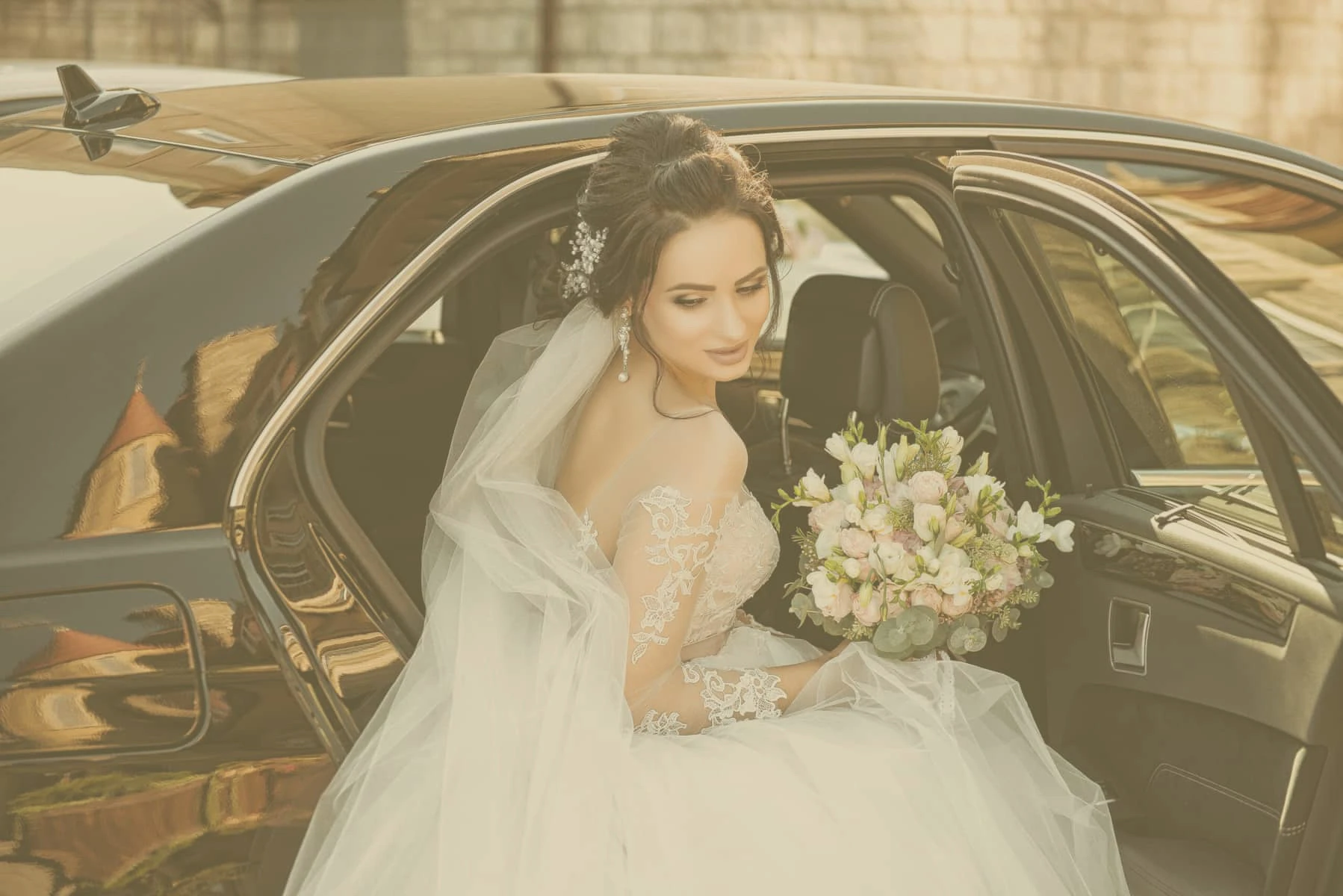 Bride out from a car on a wedding service rented on www.parisbyls.com luxury wedding chauffeur service